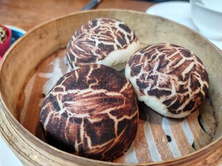 Steamed of mushroom patterns bao on bamboo container 