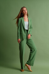 Fashionable beautiful confident woman wearing trendy suit blazer, classic trousers, floral print...