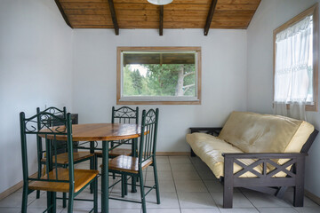 Interior of a cozy room with a wooden sofa and a table