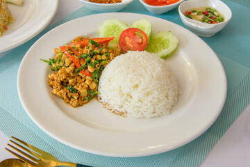 Holy basil rice with rice on a white plate