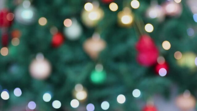 Traditional Christmas themed background. Christmas tree in 4K video blurred