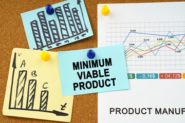 Business charts and stickers with the inscription hang on the board - MINIMUM VIABLE PRODUCT