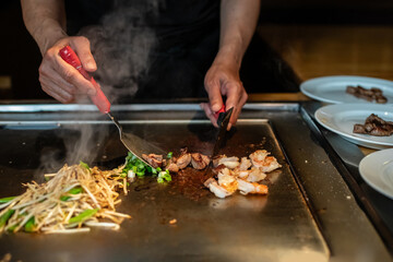 Chef cooking in Japanese teppanyaki restaurant