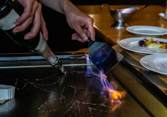 Chef cooking in Japanese teppanyaki restaurant