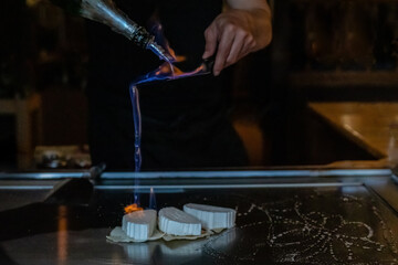 Chef cooking in Japanese teppanyaki restaurant