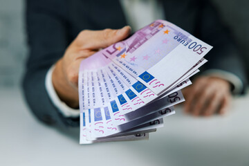 hand give 500 euro banknotes. bank money loan, consumer credit and quick loans concept