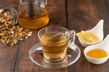 Freshly brewed hot winter tea on a wooden table