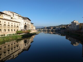The Arno river, Ponte alle Grazie Bridge and old buildings in Florence, Italy