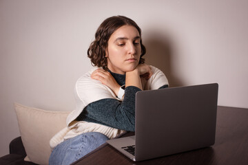 sad woman thinking, working online on laptop at home. looking for solution to serious problem