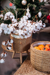 Fototapeta na wymiar New Year's atmosphere. Cotton bouquet. Persimmon in a basket.