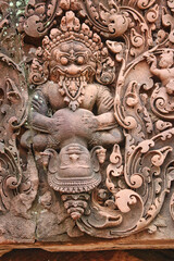Stone Bas reliefs depicting Narasimha, half-man, half-lion from hindu mythology at Banteay Srei -...