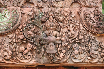 Stone Bas reliefs depicting Narasimha, half-man, half-lion from hindu mythology at Banteay Srei - 10th century Hindu temple and masterpiece of old Khmer architecture at Siem Reap, Cambodia, Asia