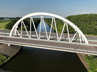 Fototapeta premium Bird's-eye view of an arch bridge over a river