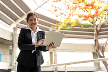 Young Asian smart businesswoman working with laptop 