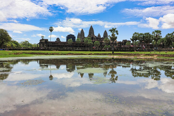 Angkor Wat Temple Complex reflected in the lake at Midday - UNESCO World Heritage 12th century masterpiece of Khmer Architecture built by Suryavarman II at Siem Reap, Cambodia, Asia