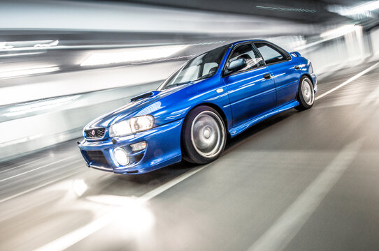 Volketswil, Zuerich, Switzerland - 05.20.2013 - A blue Subaru Impreza STI WRX with 4WD is driving in a gravel pit and garage