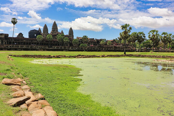 Angkor Wat Temple Complex reflected in the lake at Midday - UNESCO World Heritage 12th century...