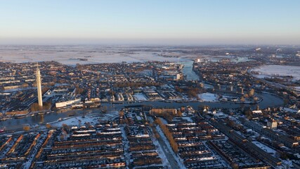Aerial shot of a city, with a river on a cloudy winter day