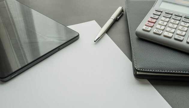 Background image with computer , tablet, pen , blank paper and calculator on the desk