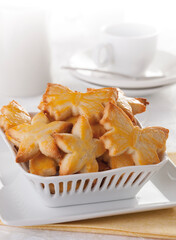 Porcelain basket with Christmas icing sugar cookies in the shape of butterflies and stars, marzipan figures.