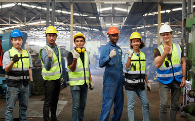 Fototapeta na wymiar group of workers or engineers raise hands and victory pose for success work and project in the factory