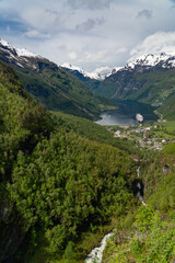 Beautiful view of the Geiranger Fjord and the town of Geiranger from the Adlerkehre with a cruise ship at anchor - 678780980