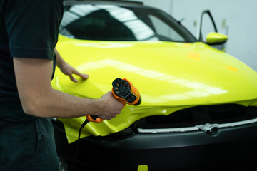 Car Detailing and Wrapping Workshop, Working on a Black and Yellow Car. Car Wrapping Process:...