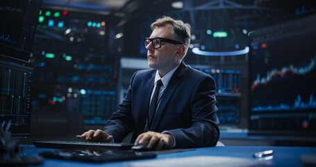 Portrait of a Smart and Thoughtful Stock Exchange Broker. Adult Man in Glasses Looking at Computer...