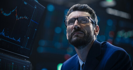 Portrait of a Handsome Bearded Stock Market Trader Working in a Stock Exchange Company. Adult Man...