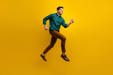 Fototapeta na wymiar Full length photo of positive nice man wear green trendy clothes look empty space black friday offer isolated on yellow color background