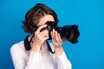 Profile portrait of young lady arms hold camera making pictures isolated on pastel blue color background © deagreez