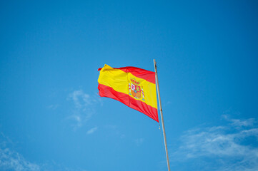 Spanish flag on cloudy sky