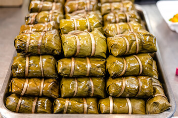 Local traditional Thai dessert, stream sticky rice known as Kao Tom Mut wrap with banana leaves.