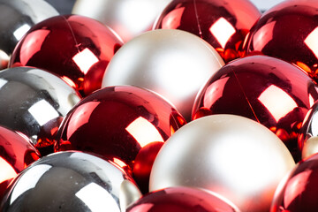 full frame background of red, silver and white mirror balls close-up with selective focus