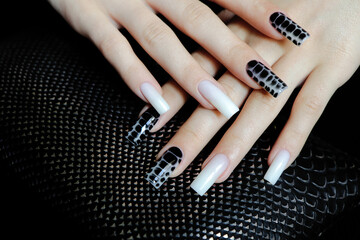 Nail design on long nails with milky white and black spreading effect on wet gel.