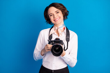 Fototapeta premium Photo of pretty positive person beaming smile hands hold camera isolated on blue color background