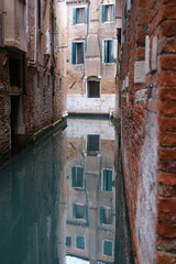 Fototapeta na wymiar A view of some reflections in a small Canal. November 14th, 2023, Venice, Italy.