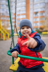 The Joyful Adventure of a Little Boy on the Swing. A little boy that is sitting on a swing