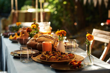 Festive table setting for traditional holiday with food and decorating with flowers