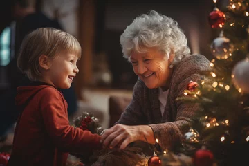 Foto op Canvas grandmother with child grandson near christmas tree, family time with grandparents © Song_about_summer