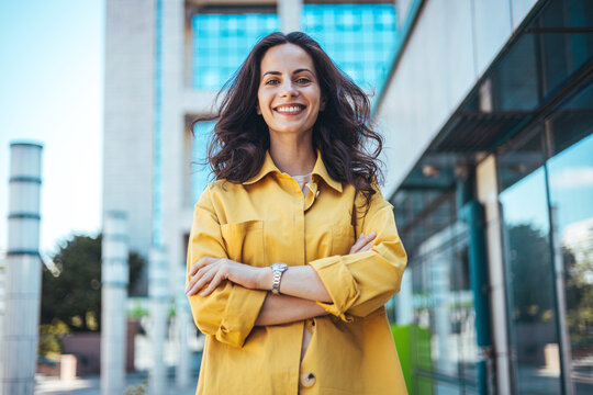 Portrait of a Stylish Pretty Young Woman in Autumn Fashion walking the city Looking at the Camera. Close-up portrait of beautiful caucasian woman with charming smile walking outdoors
