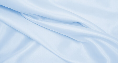 Smooth elegant blue silk or satin luxury cloth texture as abstract background. Luxurious background design