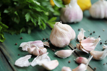 Fresh garlic cloves and ingredients to make toum sauce or a salad dressing. Closeup stock photo with selective focus and blurred background.