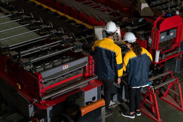 Factory quality control inspector conduct safety inspection on steel machinery and manufacturing...