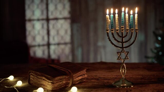 closed old book with lit candles on a candlestick 