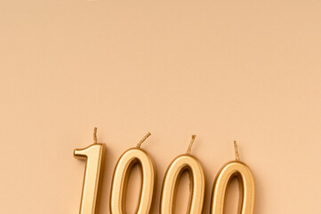 Number 1000 celebration festive background made with golden candles in the form of number Thousand. Universal holiday banner with copy space. - obrazy, fototapety, plakaty