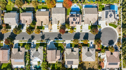 Top down view of a residential neighborhood in the suburbs in California with homes with solar panels
