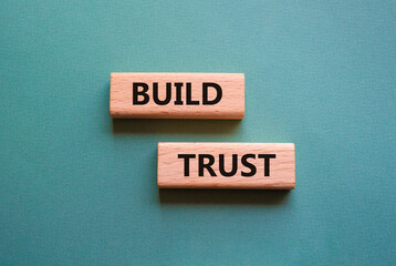 Build trust symbol. Wooden blocks with words Build trust. Beautiful grey green background. Business and Build trust concept. Copy space.