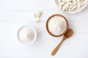 Collagen powder and pills on white background. Top view. AI Generated - obrazy, fototapety, plakaty