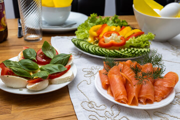 Mozzarella, salmon and cucumbers served on the table